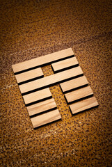 wooden Gene Key 35 i ging hexagram on rusty metal background human design
