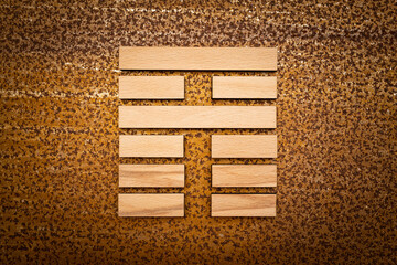 wooden Gene Key 35 i ging hexagram on rusty metal background human design