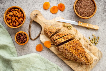 Bread with dried fruits and nuts. Healthy home baked loaf top view