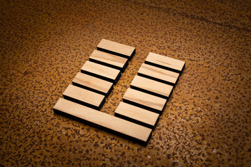 wooden Gene Key 24 i ging hexagram on rusty metal background human design