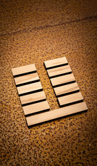 wooden Gene Key 24 i ging hexagram on rusty metal background human design