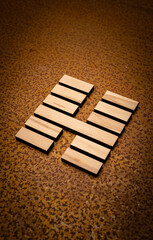 wooden Gene Key 15 i ging hexagram on rusty metal background human design