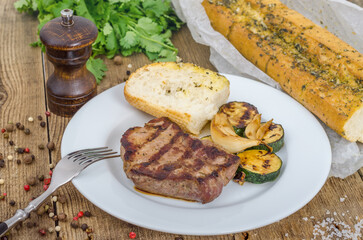 White plate with delicious grilled steak