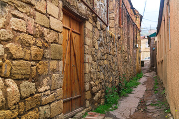 door in a narrow alley between houses in mahallas of Derbent in the historical center of the city