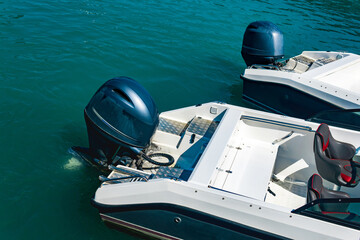 two moored motorboats with outboard motors - obrazy, fototapety, plakaty