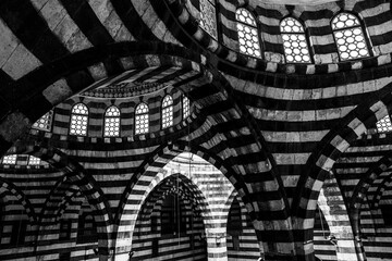 Damascus Bazaar Caravanserai, roadside inns for weary travelers and their animals especially in Middle East and along Silk Road. Ablaq black and white architecture in Khan As'ad Pasha. © Janos
