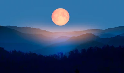 Fotobehang Volle maan Beautiful landscape with blue misty silhouettes of mountains against super blue moon "Elements of this image furnished by NASA"