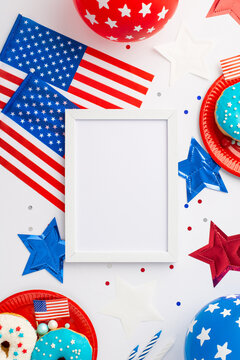 USA Independence Day concept. Top view vertical photo of photo frame national flags balloons stars plates with donuts and confetti on isolated white background with blank space