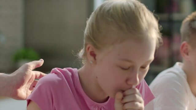 Girl laughing and choking on food at breakfast
