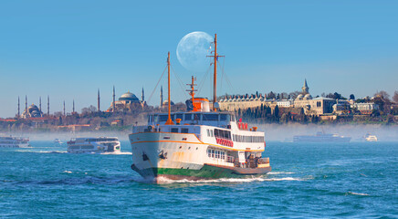 Obraz premium Famous historical peninsula of Istanbul - Hagia sophia, Sultanahmet Mosque - Istanbul, Turkey - Water trail foaming behind a passenger ferry boat - Bosphorus, Istanbul