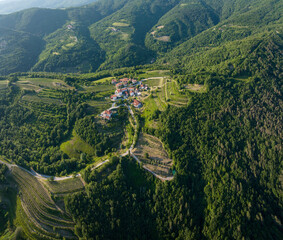 Landscape in Goriska Brda, from above with small village, vineyards, olive plantations in the middle of the forest, Slovenia - obrazy, fototapety, plakaty