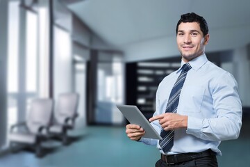 Happy successful business man posing on background