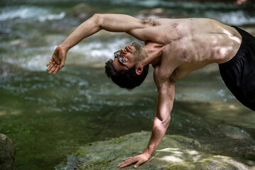 guy doing bareback yoga on the river