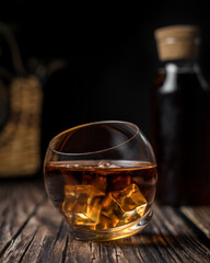 Whiskey glass in a dark and rustic environment