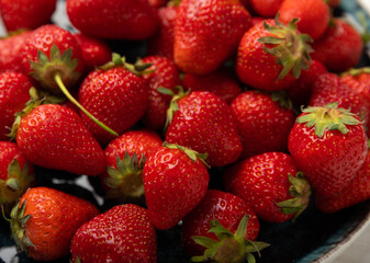 Fresh ripe juicy strawberries in a bowl on a white wooden table. Summer background composition with strawberries. Fruit concept.Vitamins.Eco berries. Copy space
