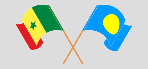 Crossed and waving flags of Senegal and Palau