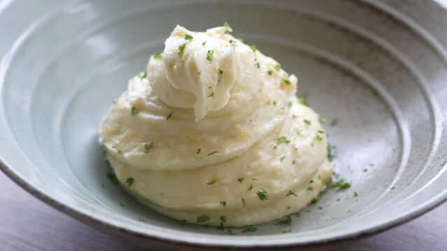 Mashed potatoes in bowl on wooden rustic table