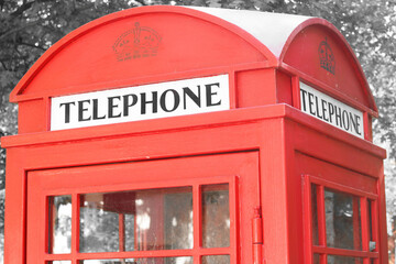 Black and white photo with red telephone booth in classic english style on black and white background in style of black and white retro photo as sample of black and white photo with red accent