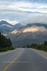 highway with background of mountains and sunbeams through the clouds, Patagonia Argentina