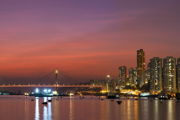 Fototapeta na wymiar Idyllic landscape of harbor and skyline of Hong Kong city at dusk