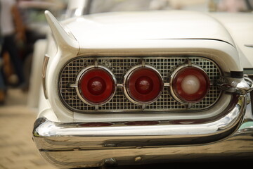 Rear Close-Up of a Classic White American Car with Iconic Tailfins and Triple Taillights