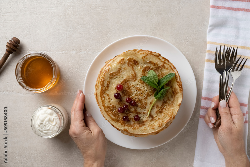 Wall mural Big pancakes on the table, cooking delicious homemade pancakes