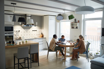 Fototapeta Wide angle home scene of modern multiethnic family at dinner table in kitchen, copy space obraz