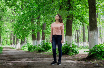 Fototapeta premium beautiful woman walking through a forest on a beautiful summer day