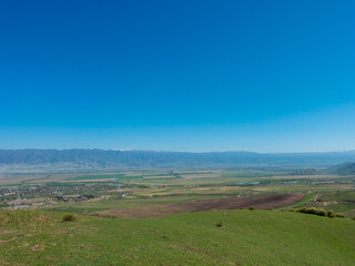 Fototapeta na wymiar Green slopes and blue skies. Kyrgyzstan. tourism and travel