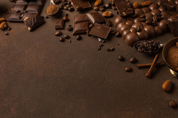 Chocolate background with chocolate pieces, chocolate chips, nuts, cocoa