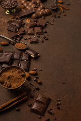 Chocolate background with chocolate pieces, chocolate chips, nuts, cocoa