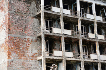 Fragment of an abandoned residential multi-storey building. Destroyed balconies, lack of windows and doors