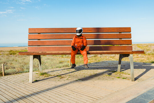 Spaceman Sitting On Giant Bench