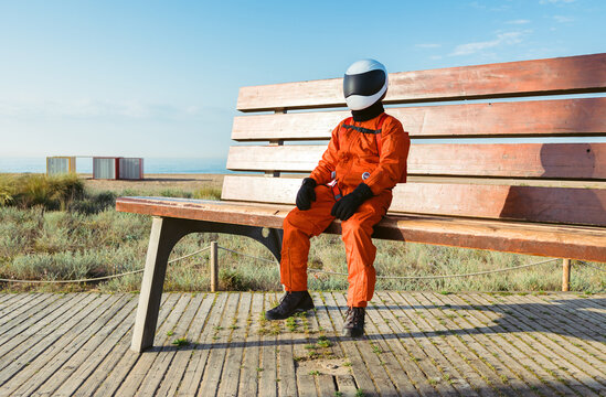 Spaceman sitting on giant bench