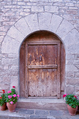 Fototapeta na wymiar Old vintage door on rustic stone building in the village of Aragon, Spain