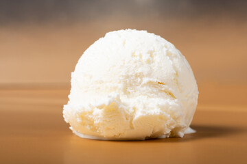 vanilla scoop of sundae ice cream  on brown background, close up