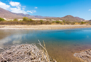 River among the mountains. Calm transparent ovda. Summer landscape. Boom Gorge, Kyrgyzstan.