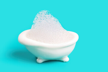 Miniature bathtub full of soap bubbles