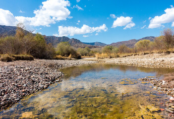 River among the mountains. Calm transparent ovda. Summer landscape. Boom Gorge, Kyrgyzstan.