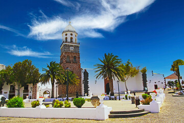 Beautiful canary town square, red brick stone church bell tower, flawless white houses, palm trees...