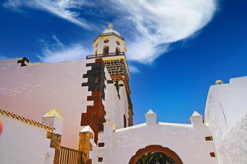 Typical colonial canarian spanish style church bell tower against clear blue summer sky, flawless...