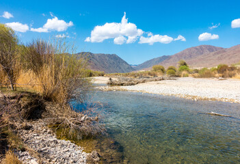 River among the mountains. Calm transparent ovda. Summer landscape. Boom Gorge, Kyrgyzstan.