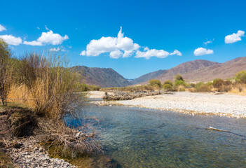 River among the mountains. Calm transparent ovda. Summer landscape. Boom Gorge, Kyrgyzstan.