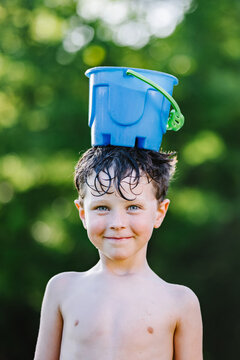 Boy with bucket on head