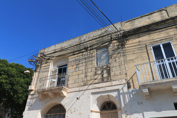 Fototapeta na wymiar Messy electrical cables on wall corner in Malta