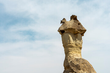 The hat of a fairy chimney on blue sky background in Cappadocia. Space for text.