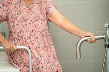 Asian senior or elderly old lady woman patient use toilet bathroom handle security in nursing...