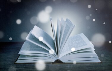 Old book or Holy Bible open on a table background with light