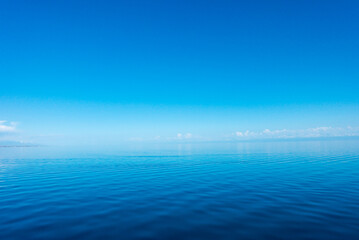 Blue sea water. Water and sky. Natural ocean surface background on the sky.
