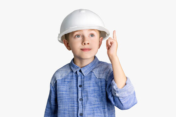 Child wearing a construction helmet on his head looks thoughtfully and raises his index finger up. Little boy engineer, architector or builder shows an idea gesture.